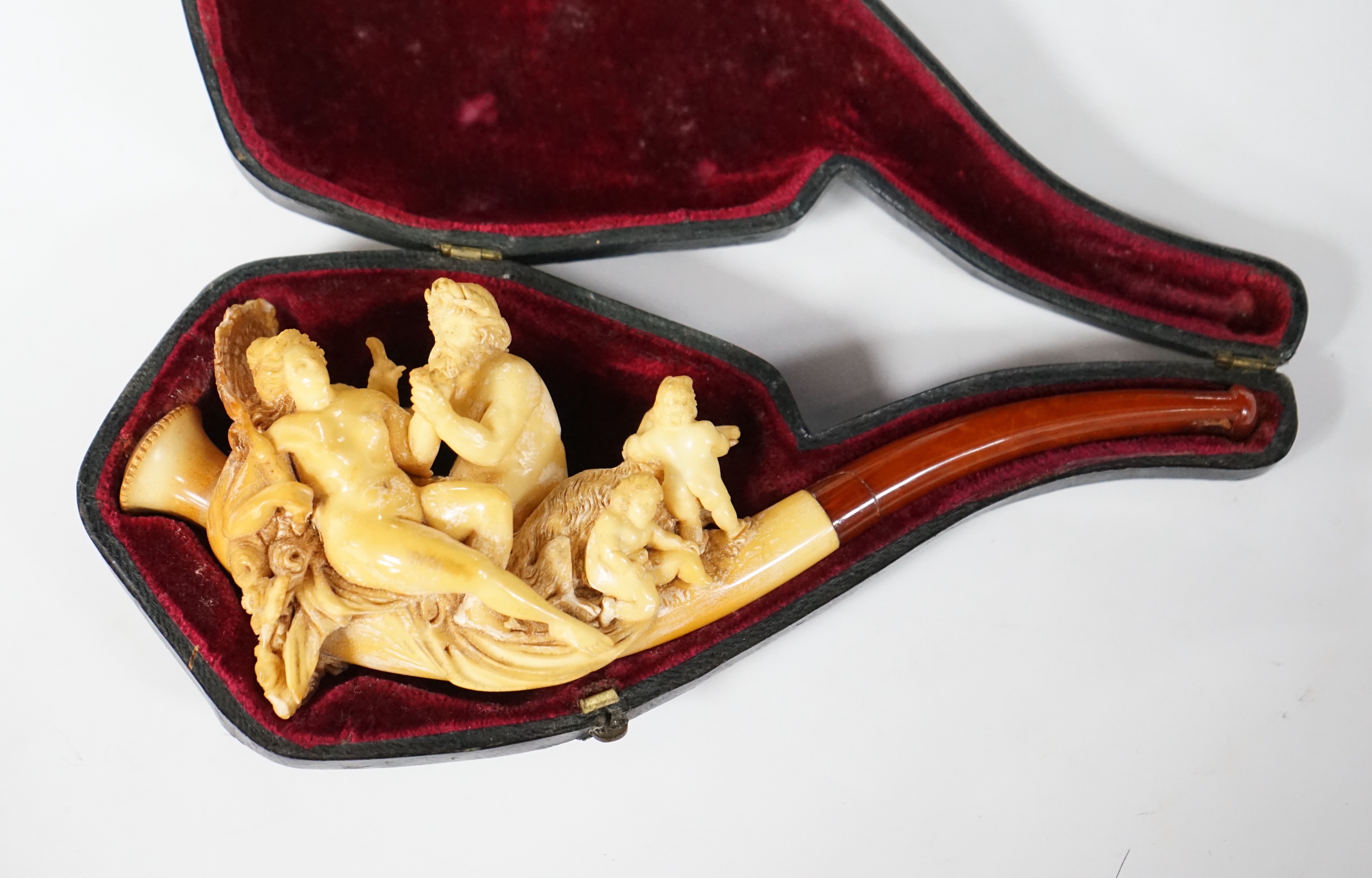 A cased ornate Meerschaum pipe, early 20th century, intricately carved with the figures of Mars and Rhea Silvia with Romulus and Remus and the wolf on the bowl, 18cm long